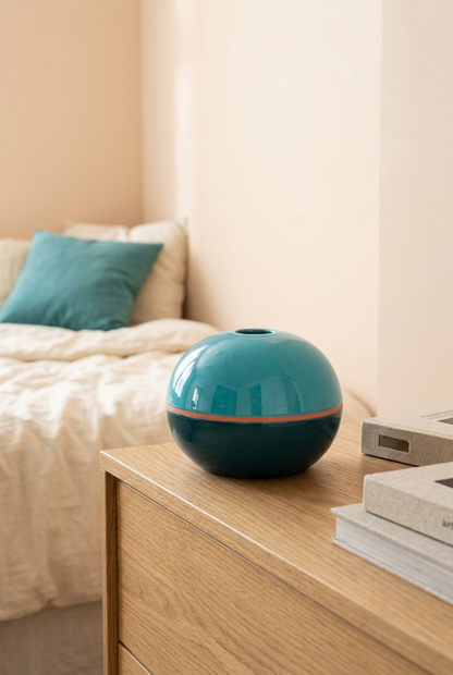 Tide Orbit vase on bedroom dresser with peach backdrop
